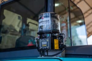 An Alemlube lube system mounted to a Kobelco excavator